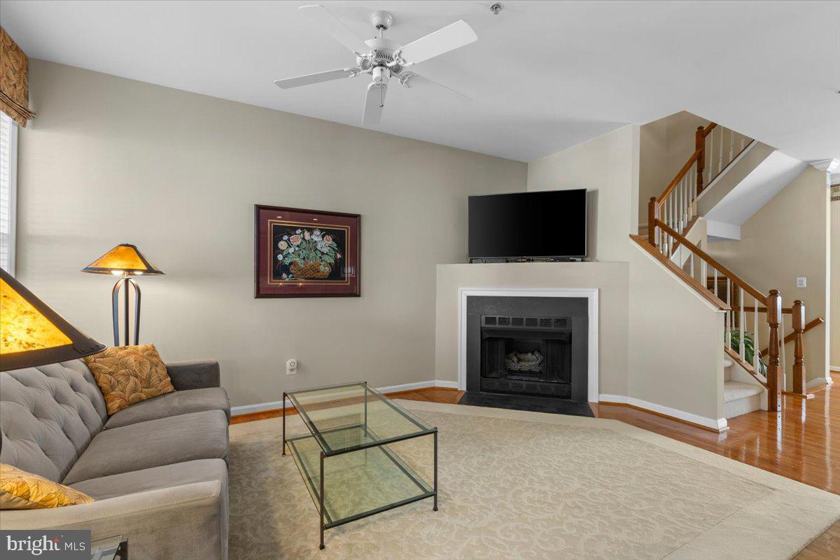 46134 Brisbane Square Sterling, VA 20165 - Photo 12 of 48 a living room with furniture a flat screen tv and a fireplace