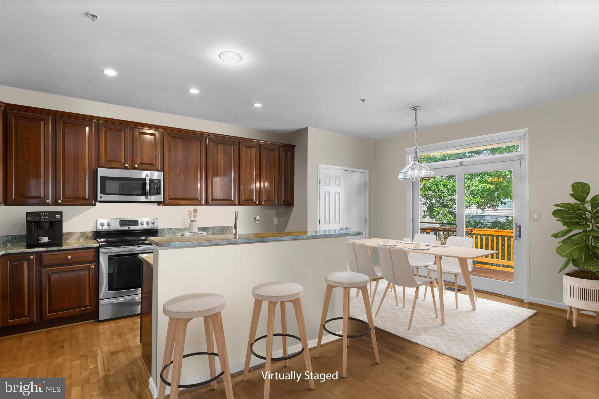 46134 Brisbane Square Sterling, VA 20165 - Photo 13 of 48 a kitchen with stainless steel appliances granite countertop a stove top oven a sink dishwasher a dining table and chairs with wooden floor