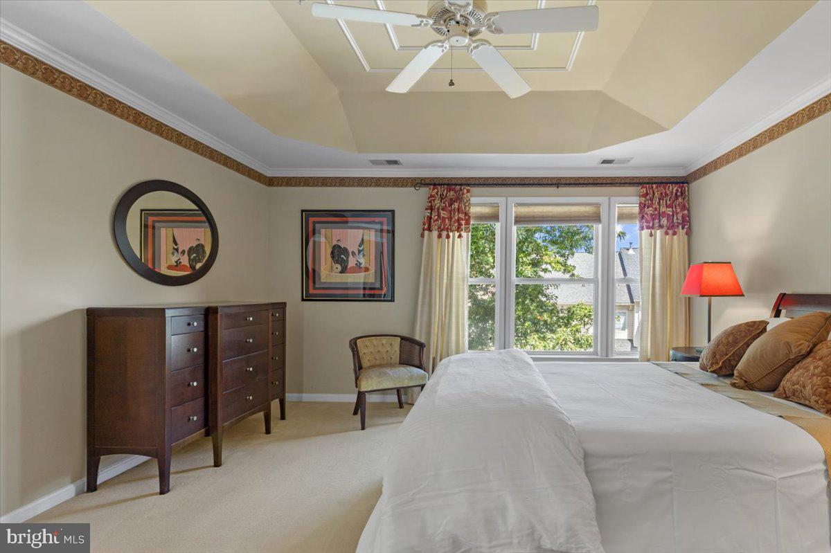 46134 Brisbane Square Sterling, VA 20165 - Photo 23 of 48 a bedroom with a bed a clock on dresser and a large window