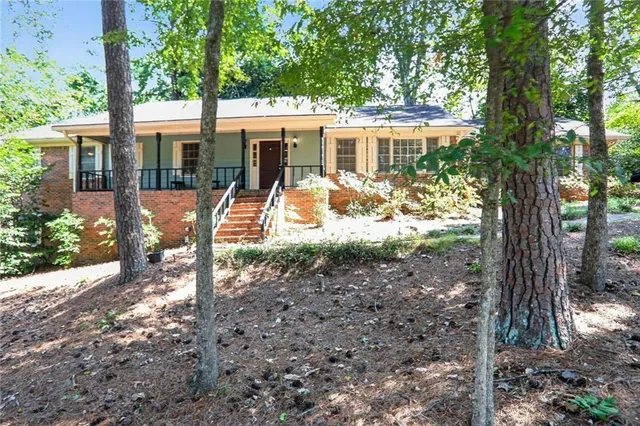 a front view of a house with a yard table and chairs