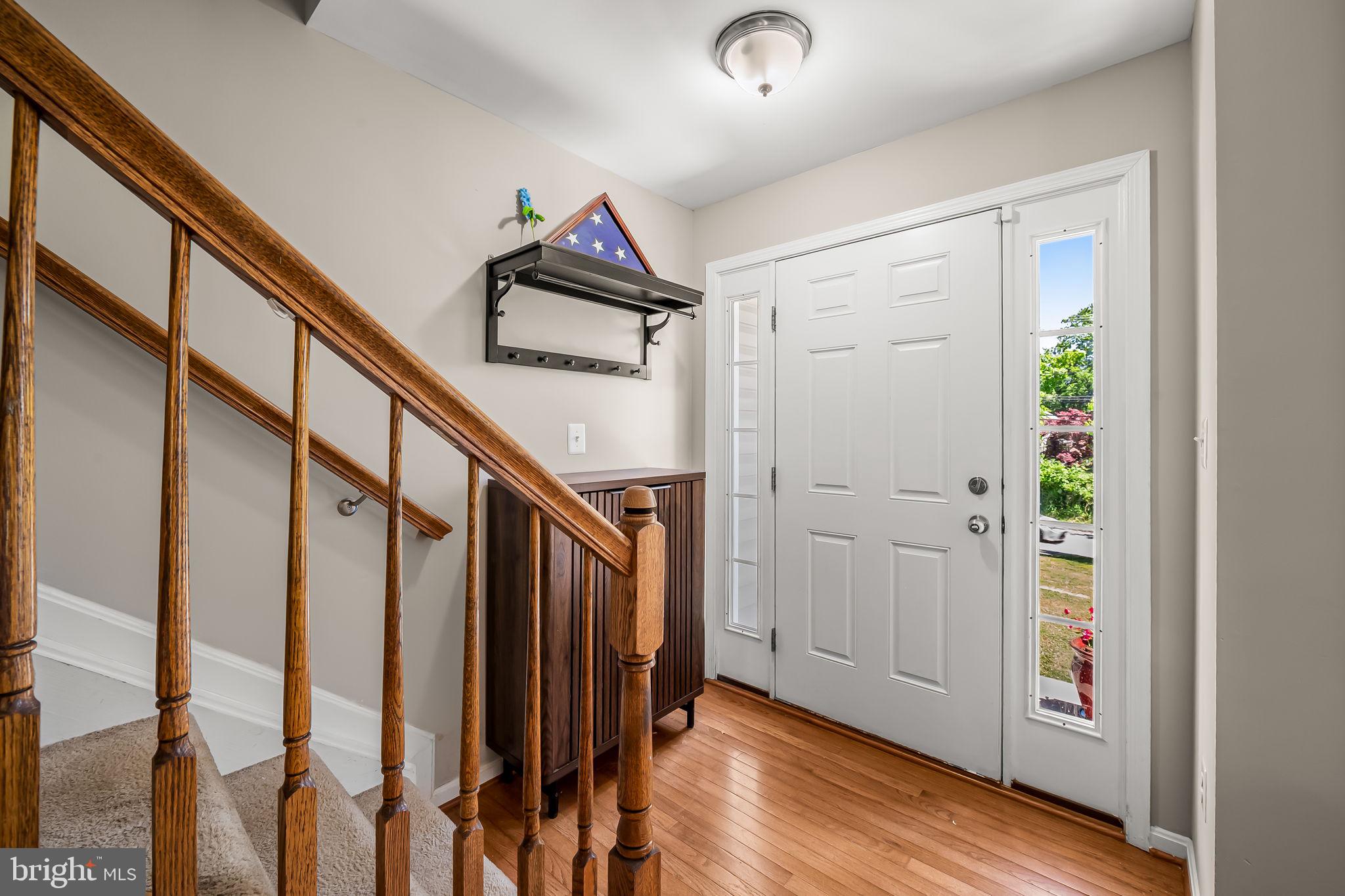 6008 Hanover Road Elkridge, MD 21075 - Photo 2 of 36 a view of a hallway with wooden floor and stairs