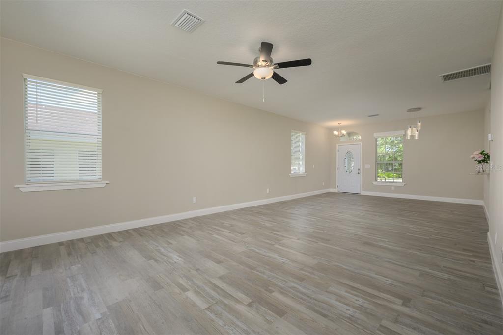 6227 Blue Runner Court Lakewood Ranch, FL 34202 - Photo 12 of 46 a view of an empty room with wooden floor and a window