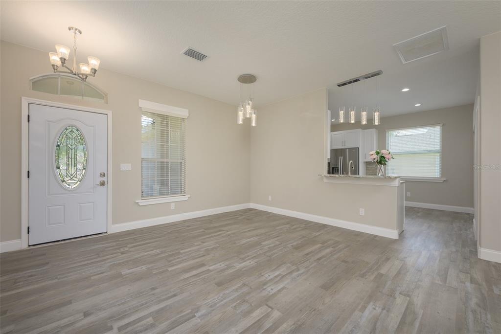 6227 Blue Runner Court Lakewood Ranch, FL 34202 - Photo 14 of 46 an empty room with wooden floor and windows