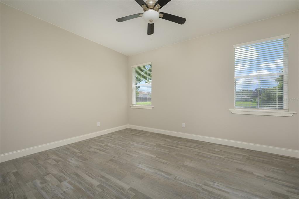 6227 Blue Runner Court Lakewood Ranch, FL 34202 - Photo 18 of 46 wooden floor in an empty room with a window