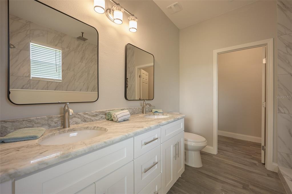 6227 Blue Runner Court Lakewood Ranch, FL 34202 - Photo 21 of 46 a bathroom with 2 sink and a mirror