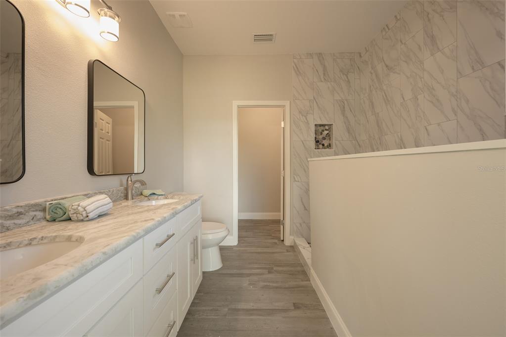 6227 Blue Runner Court Lakewood Ranch, FL 34202 - Photo 22 of 46 a bathroom with a double vanity sink and a mirror