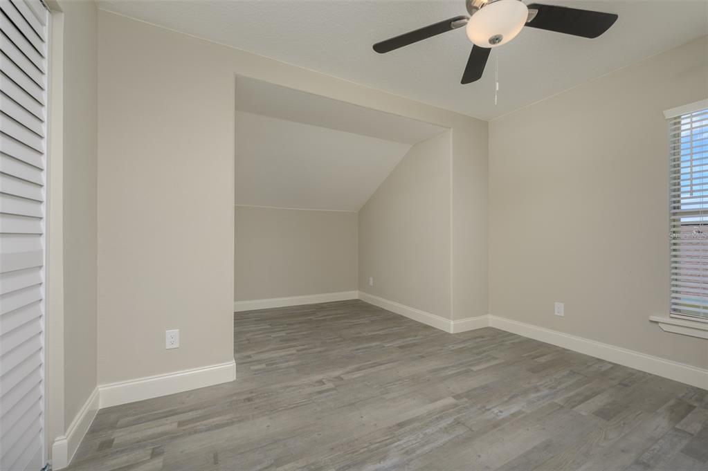 6227 Blue Runner Court Lakewood Ranch, FL 34202 - Photo 28 of 46 an empty room with a window and a ceiling fan