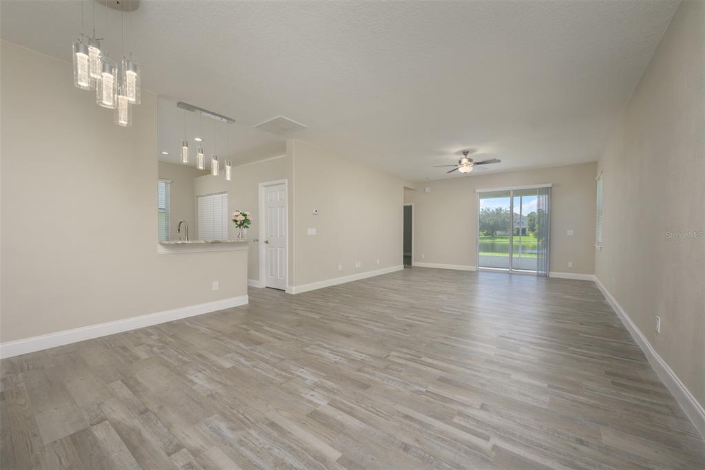 6227 Blue Runner Court Lakewood Ranch, FL 34202 - Photo 9 of 46 an empty room with wooden floor and windows