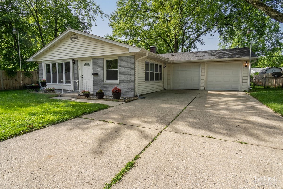 53 Marnel Road Montgomery, IL 60538 - Photo 3 of 33 a front view of a house with a garden and trees