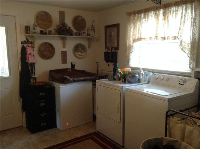 320 Jackson Road Portland, TN 37148 - Photo 6 of 20 oversized laundry room with cabinets and closet for added storage with rear entrance to home.