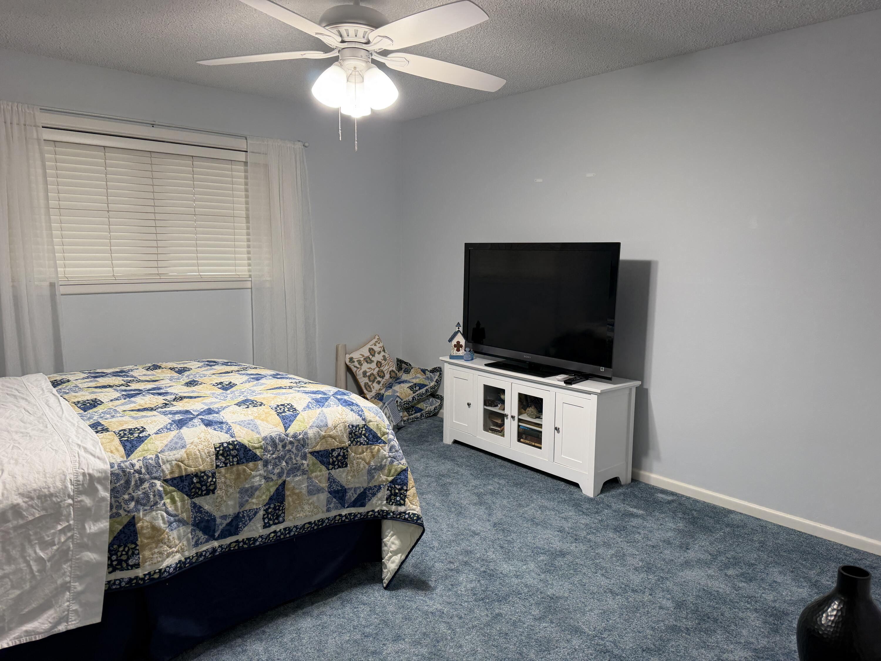 1603 South 8th Street Lamesa, TX 79331 - Photo 10 of 39 a bedroom with a bed and a flat screen tv