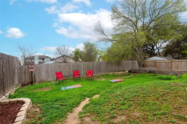 a garden with flowers and wooden fence