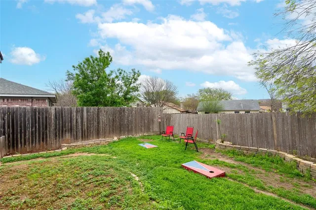 a view of yard with small play house and slide