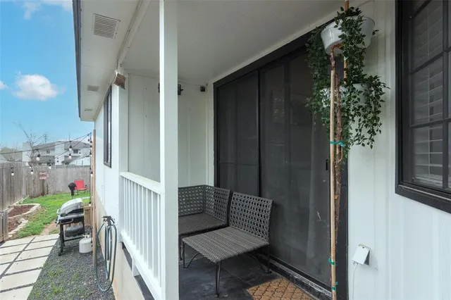 a view of a dining room with furniture and a chandelier