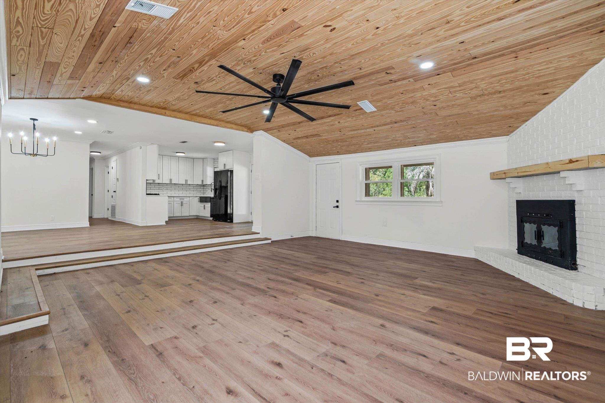 4156 Furman Drive Mobile, AL 36619 - Photo 4 of 24 Unfurnished living room with light wood-style floors, a brick fireplace, vaulted ceiling, recessed lighting, and a ceiling fan