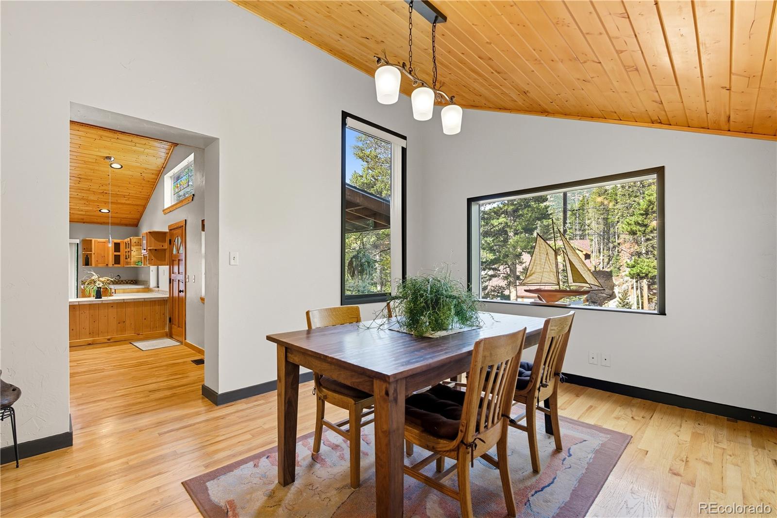 401 Lake Road Idaho Springs, CO 80452 - Photo 11 of 47 a view of a dining room with furniture window and wooden floor