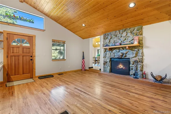 a kitchen with stainless steel appliances granite countertop a sink a stove and a refrigerator