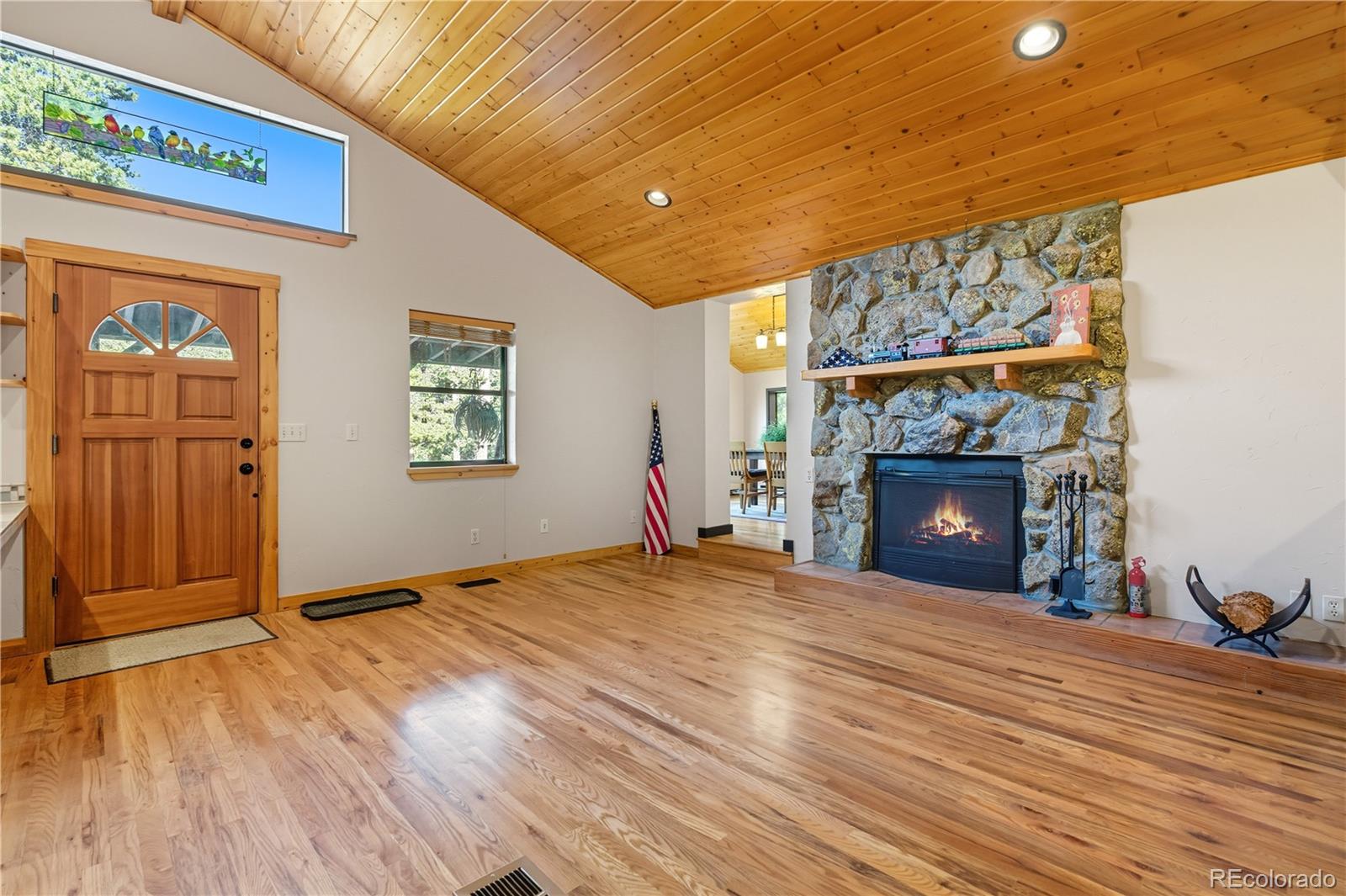401 Lake Road Idaho Springs, CO 80452 - Photo 12 of 47 a view of empty room with wooden floor and fireplace