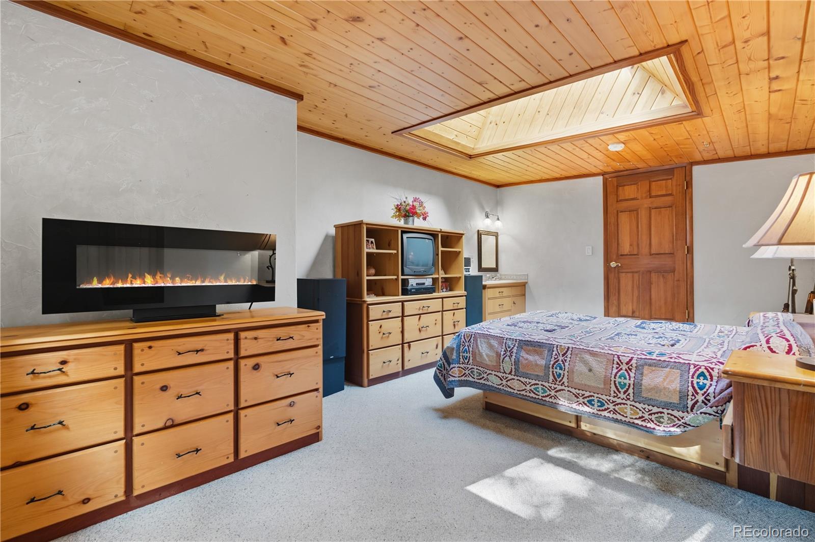 401 Lake Road Idaho Springs, CO 80452 - Photo 15 of 47 a bedroom with a bed and a flat screen tv