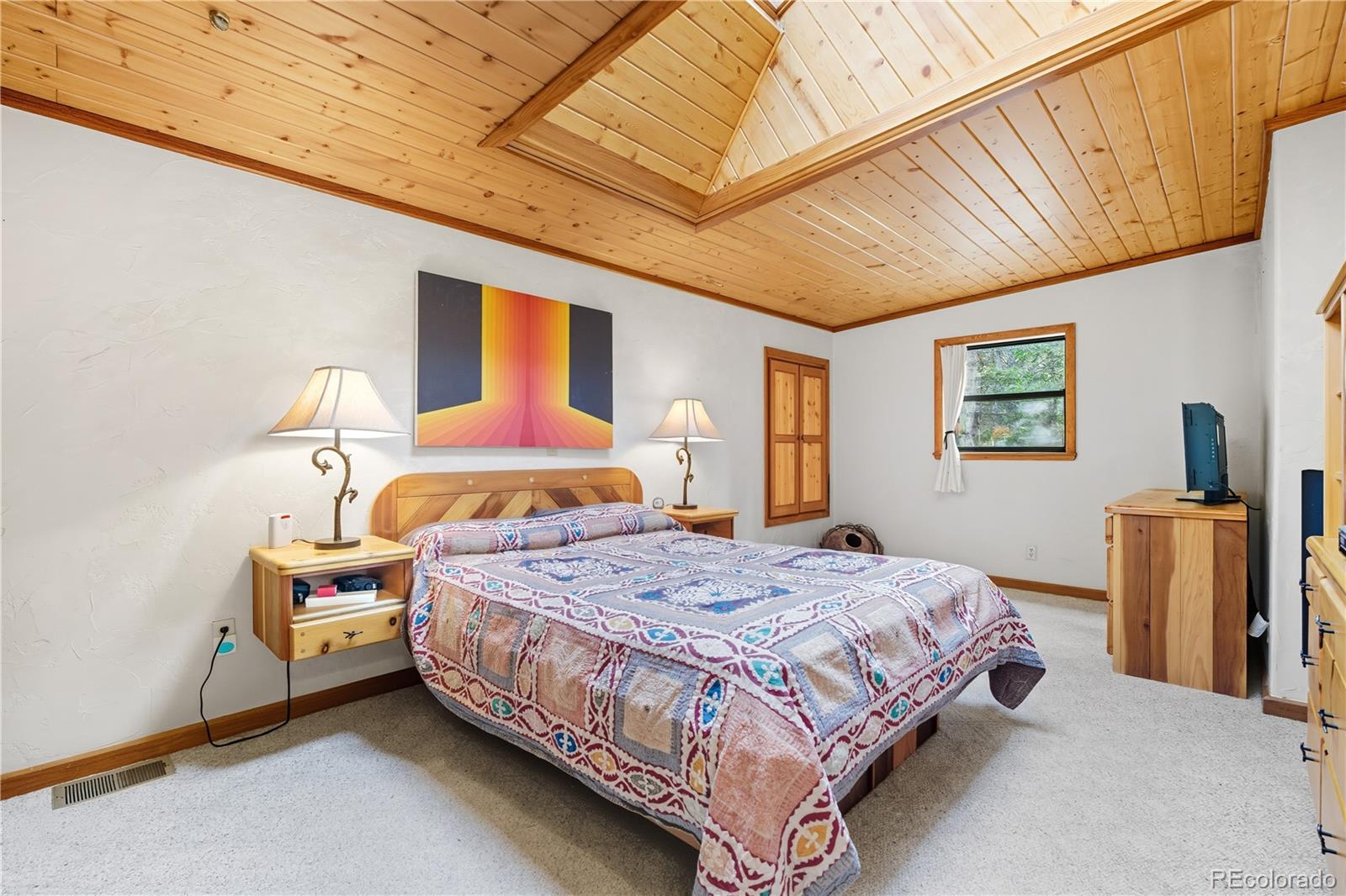 401 Lake Road Idaho Springs, CO 80452 - Photo 16 of 47 a bedroom with a bed wooden floor and window