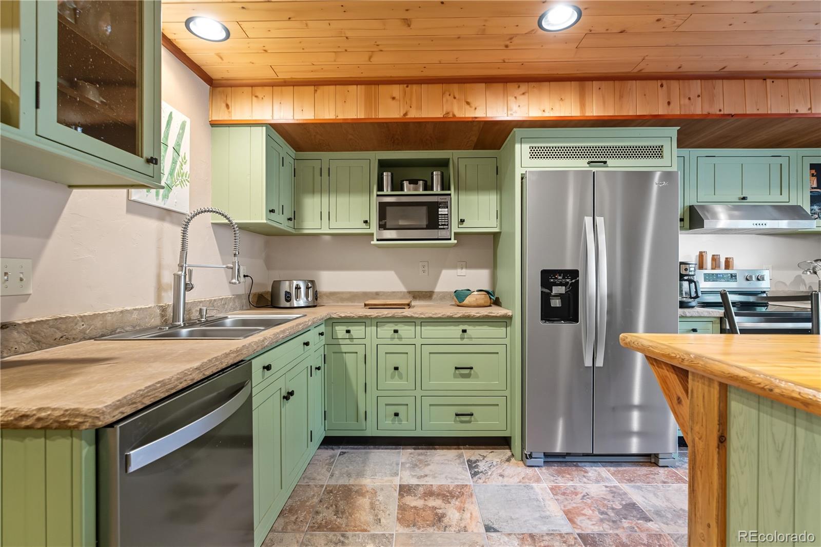 401 Lake Road Idaho Springs, CO 80452 - Photo 17 of 47 a kitchen with a sink a refrigerator and cabinets