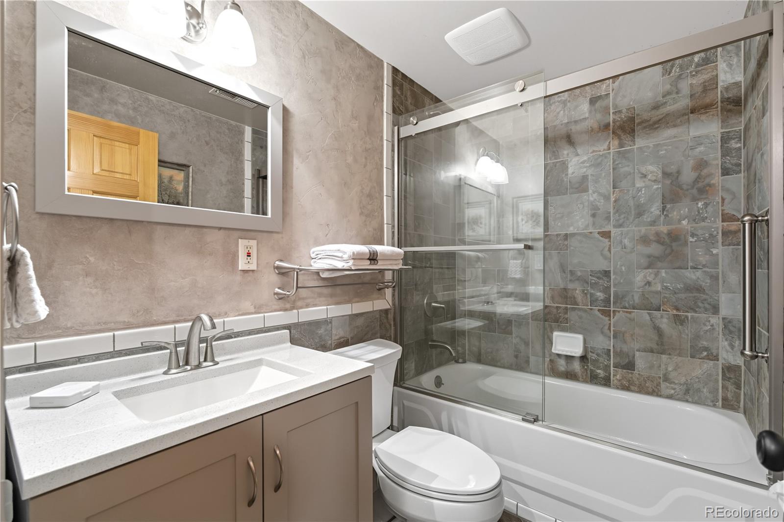 401 Lake Road Idaho Springs, CO 80452 - Photo 19 of 47 a bathroom with a sink mirror toilet and bathtub