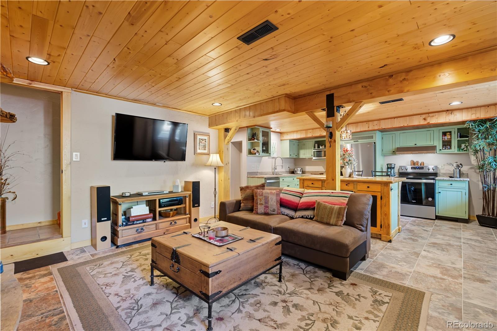 401 Lake Road Idaho Springs, CO 80452 - Photo 22 of 47 a living room with furniture and a flat screen tv