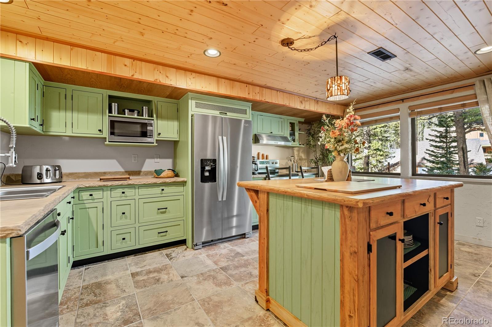 401 Lake Road Idaho Springs, CO 80452 - Photo 23 of 47 a kitchen with stainless steel appliances granite countertop a stove a sink dishwasher and a refrigerator