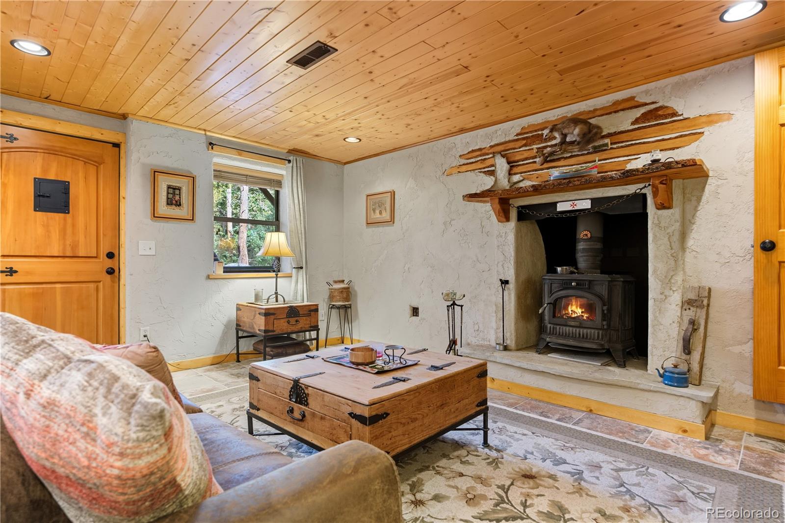 401 Lake Road Idaho Springs, CO 80452 - Photo 29 of 47 a living room with furniture and a fireplace