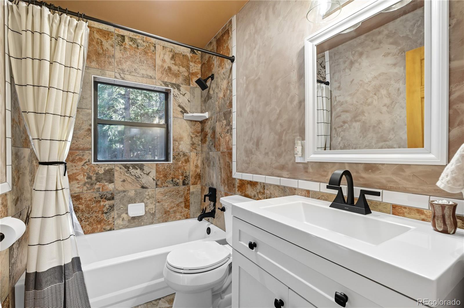 401 Lake Road Idaho Springs, CO 80452 - Photo 30 of 47 a bathroom with a sink toilet and shower