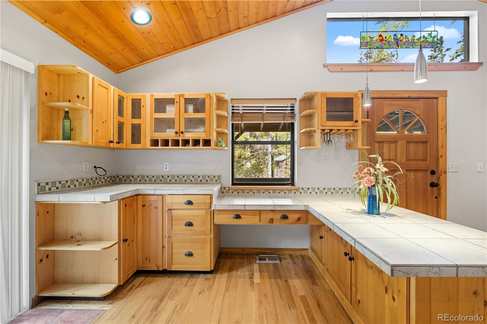 401 Lake Road Idaho Springs, CO 80452 - Photo 8 of 47 a kitchen with a refrigerator a sink and dishwasher with wooden floor
