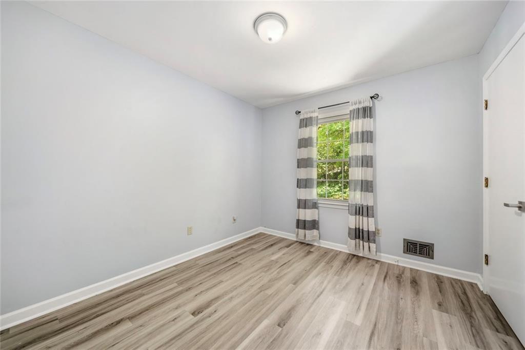 2702 Davenport Road Northwest Duluth, GA 30096 - Photo 15 of 48 an empty room with wooden floor and windows