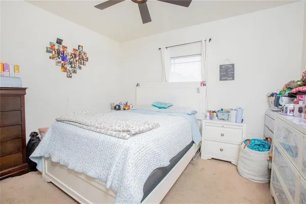 a bed room with a bed and a chair