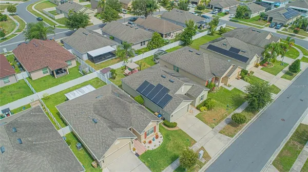 an aerial view of residential houses with outdoor space