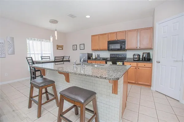 a kitchen with granite countertop lots of counter top space and cabinets