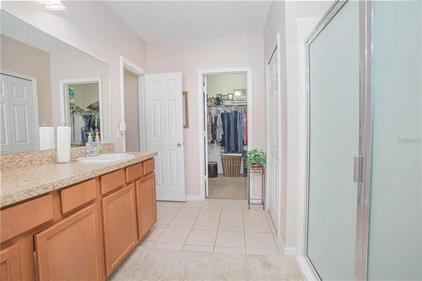 a spacious bathroom with a shower and a sink