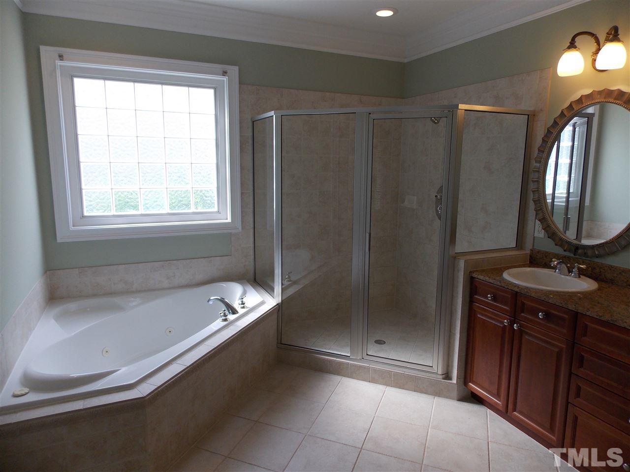 12233 Beestone Lane Raleigh, NC 27614 - Photo 14 of 25 a bathroom with a tub a sink and a shower