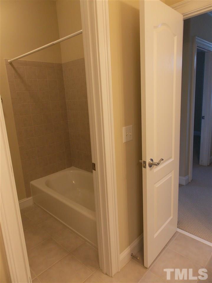 12233 Beestone Lane Raleigh, NC 27614 - Photo 21 of 25 a bathroom with a bathtub