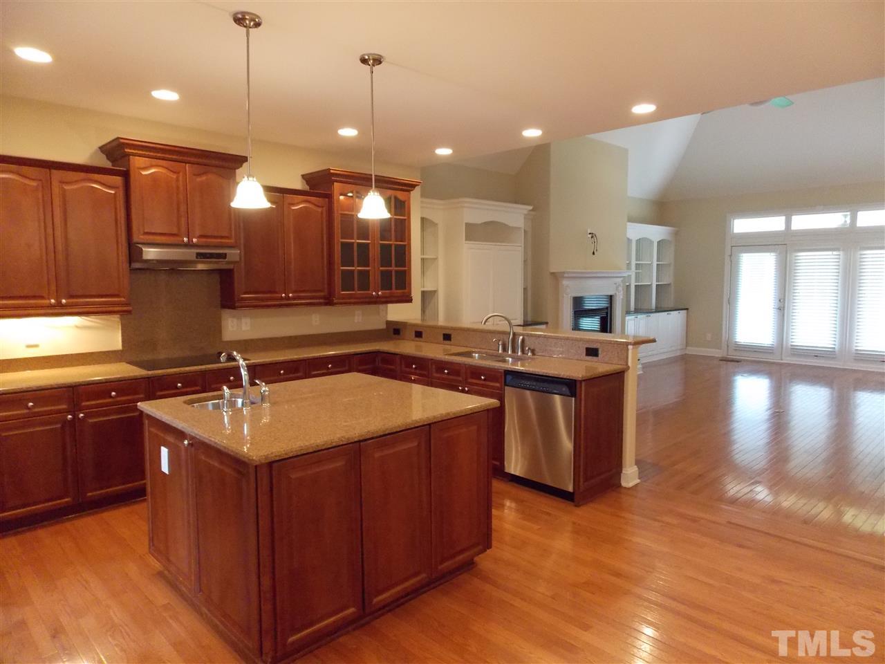 12233 Beestone Lane Raleigh, NC 27614 - Photo 5 of 25 a kitchen with stainless steel appliances granite countertop a sink a stove and a wooden floors
