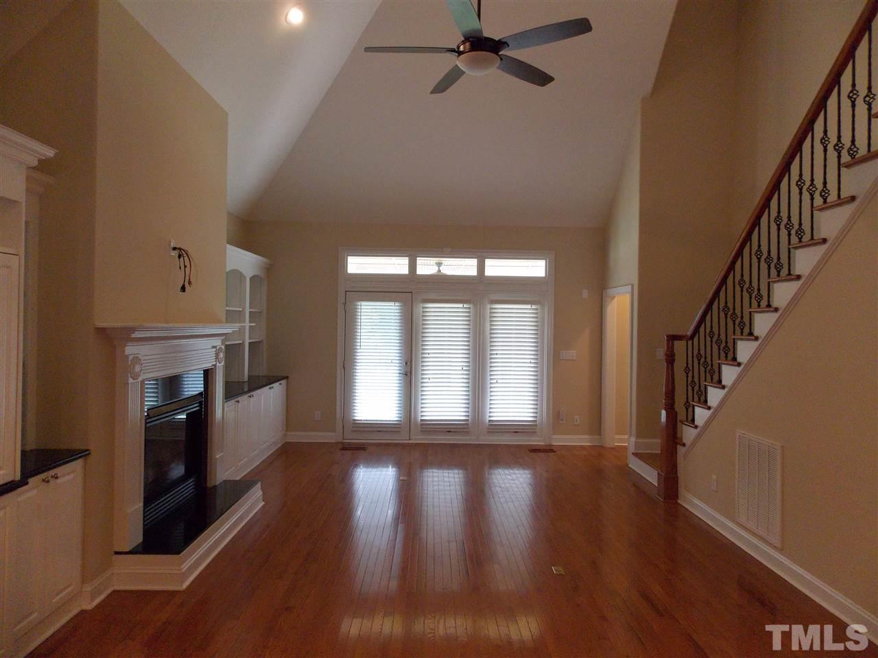 12233 Beestone Lane Raleigh, NC 27614 - Photo 8 of 25 a living room with fireplace and wooden floor