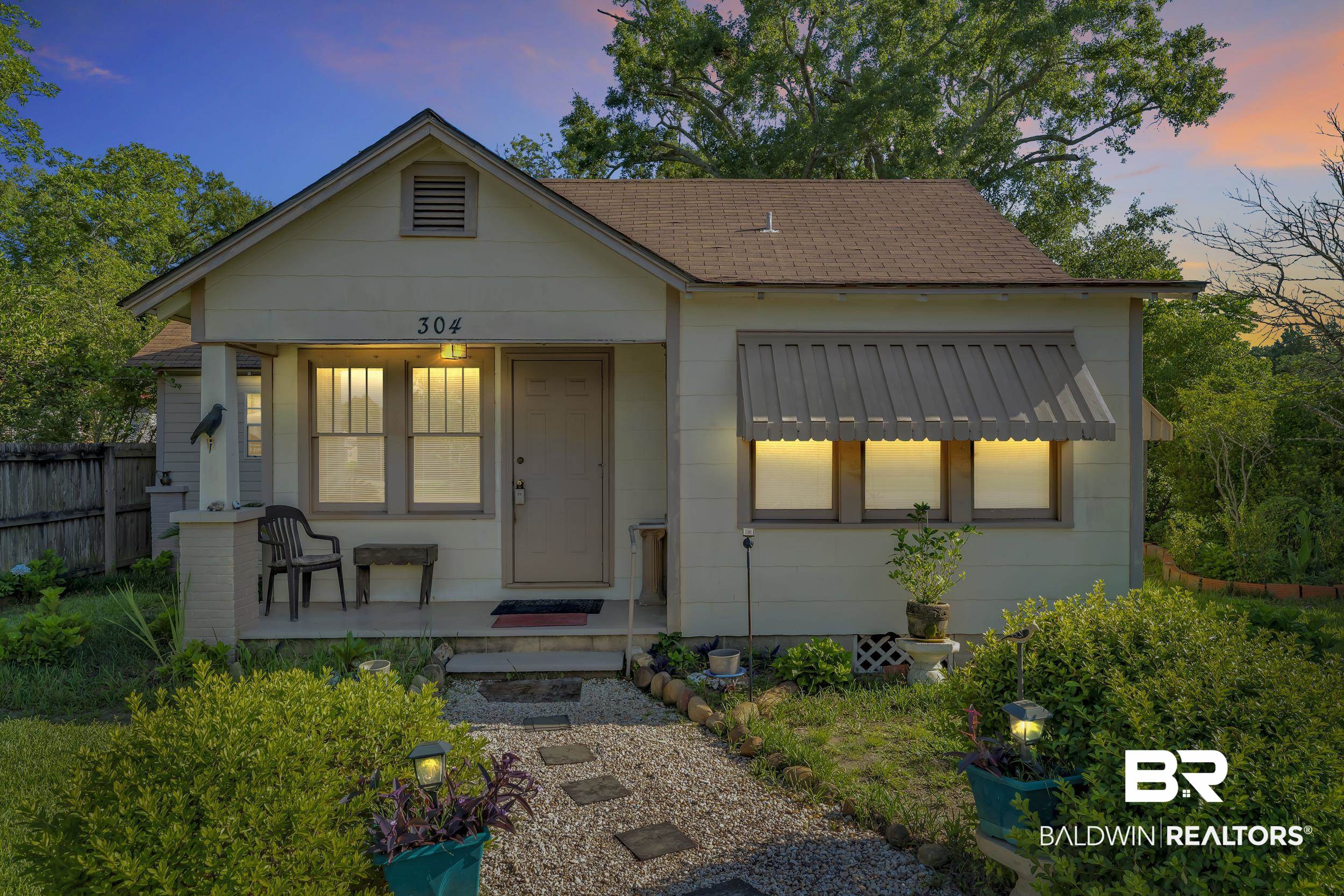 304 West Myrtle Avenue Foley, AL 36535 - Photo 27 of 29 Charming single-story exterior with light-colored siding and a brown shingle roof