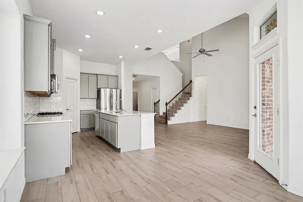 a kitchen with stainless steel appliances a refrigerator and a stove top oven