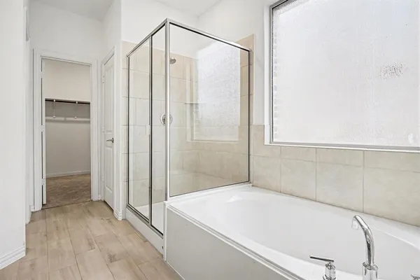 a bathroom with a bathtub and a shower