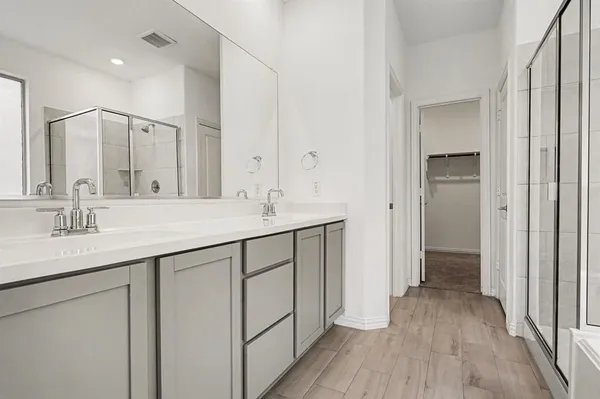 a bathroom with a double vanity sink and mirror