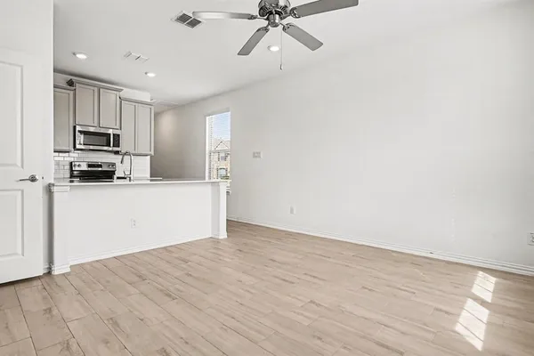 a view of a kitchen with microwave and cabinets