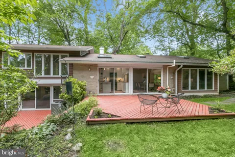 a view of backyard of house with green space