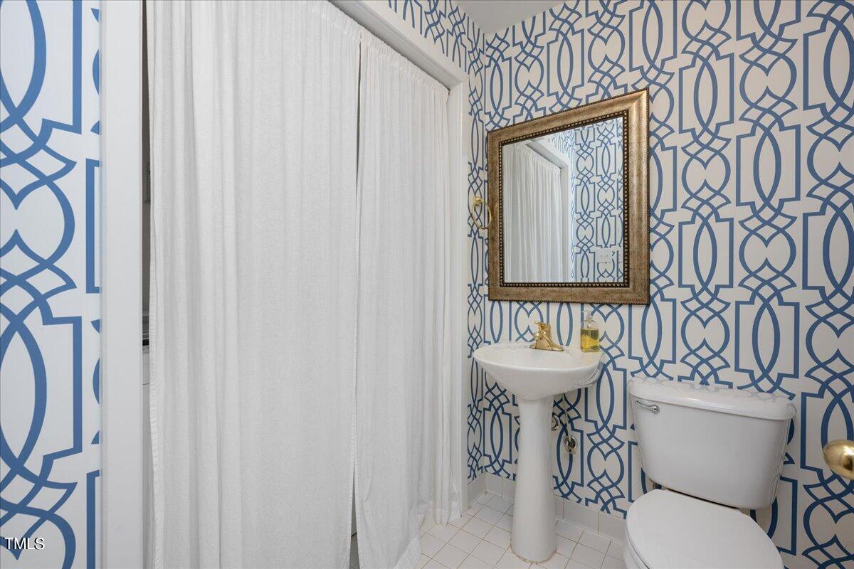 2803 Exeter Circle Raleigh, NC 27608 - Photo 17 of 38 a bathroom with a sink and mirror with toilet