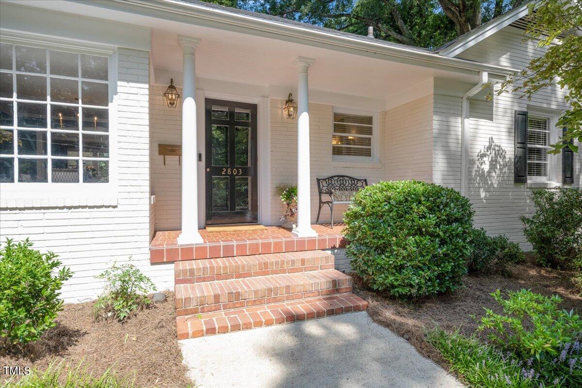 2803 Exeter Circle Raleigh, NC 27608 - Photo 3 of 38 a front view of a house with a yard and potted plants