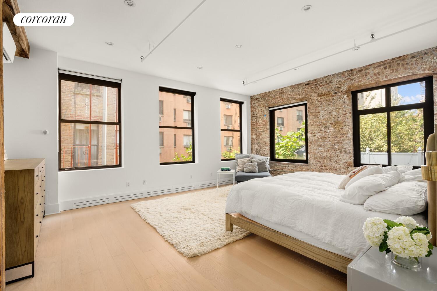 430 East 10th Street, Unit 2B Manhattan, NY 10009 - Photo 5 of 9 a spacious bedroom with a large bed and large windows