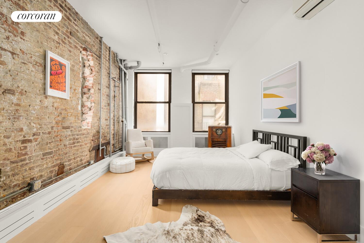 430 East 10th Street, Unit 2B Manhattan, NY 10009 - Photo 7 of 9 a bedroom with a bed and a window